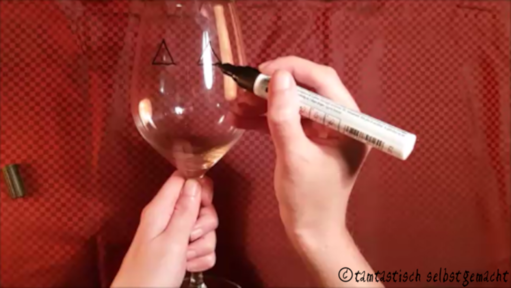 Weinglas wird mit Glasmalstift bemalt